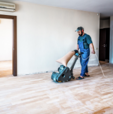 Preparing to vacuum empty room with wooden floor