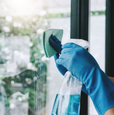 Washing windows with rage and spray bottle